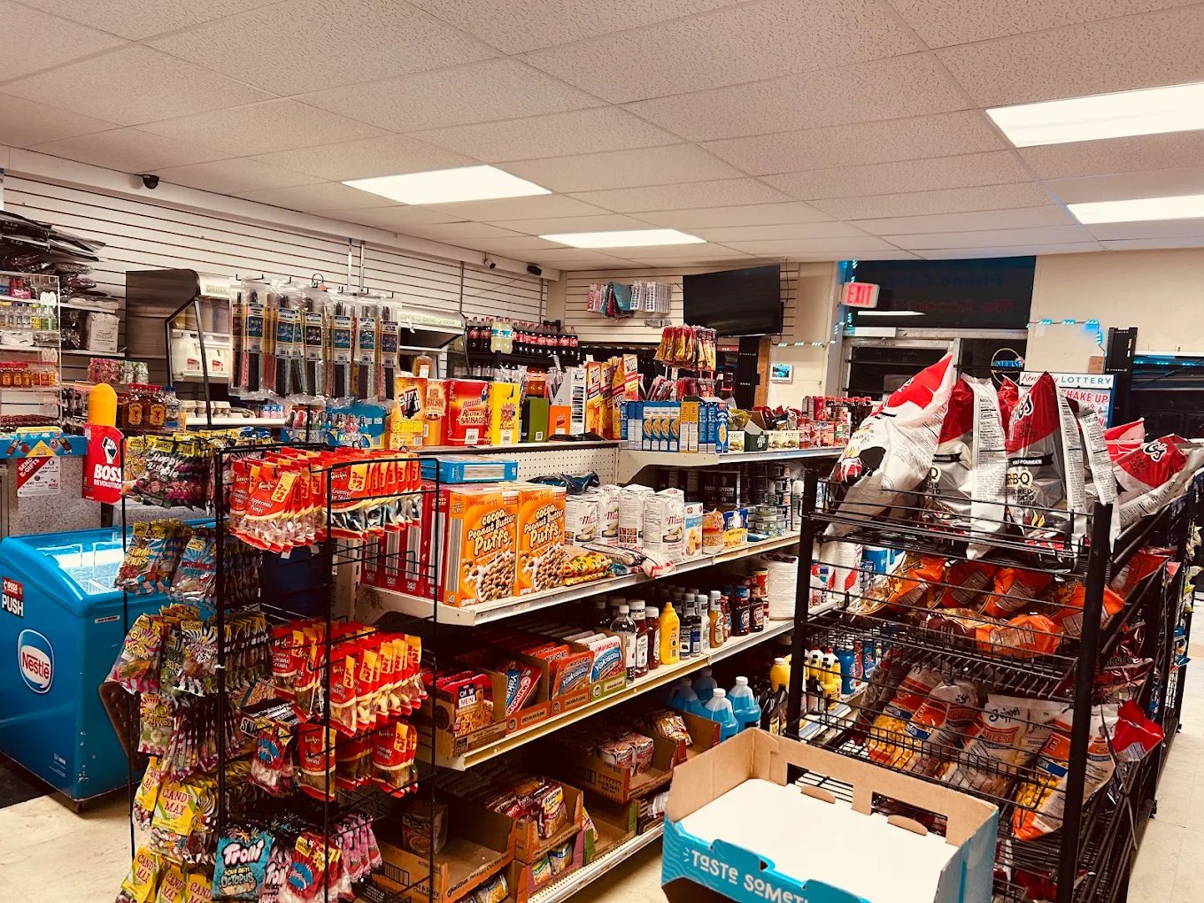 Interior aisles of Garrard's Mini Mart stocked with snacks, cereal, and grocery items